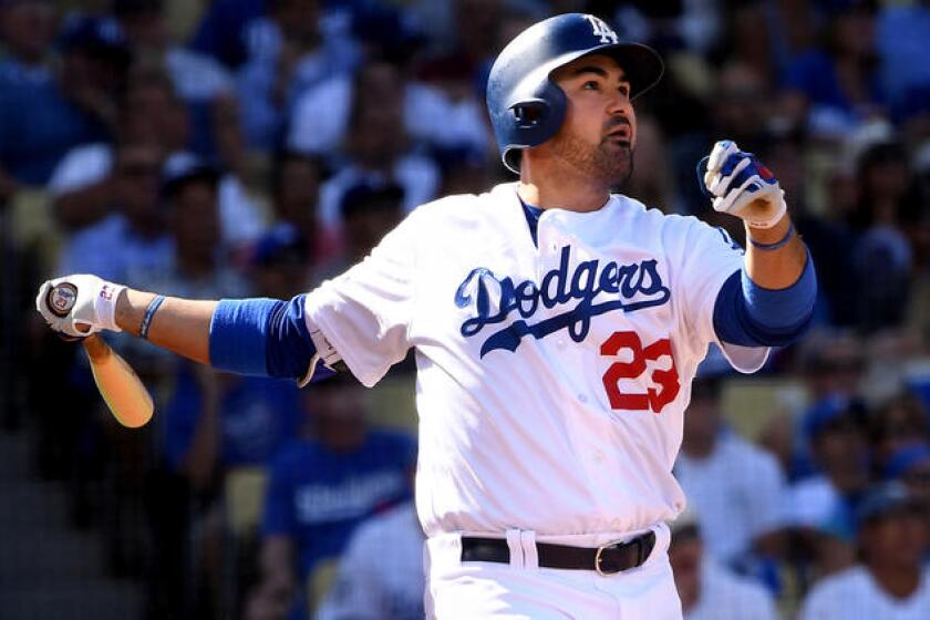 Adrian Gonzalez follows through on a two-run home run against the Nationals in the first inning of Game 4.