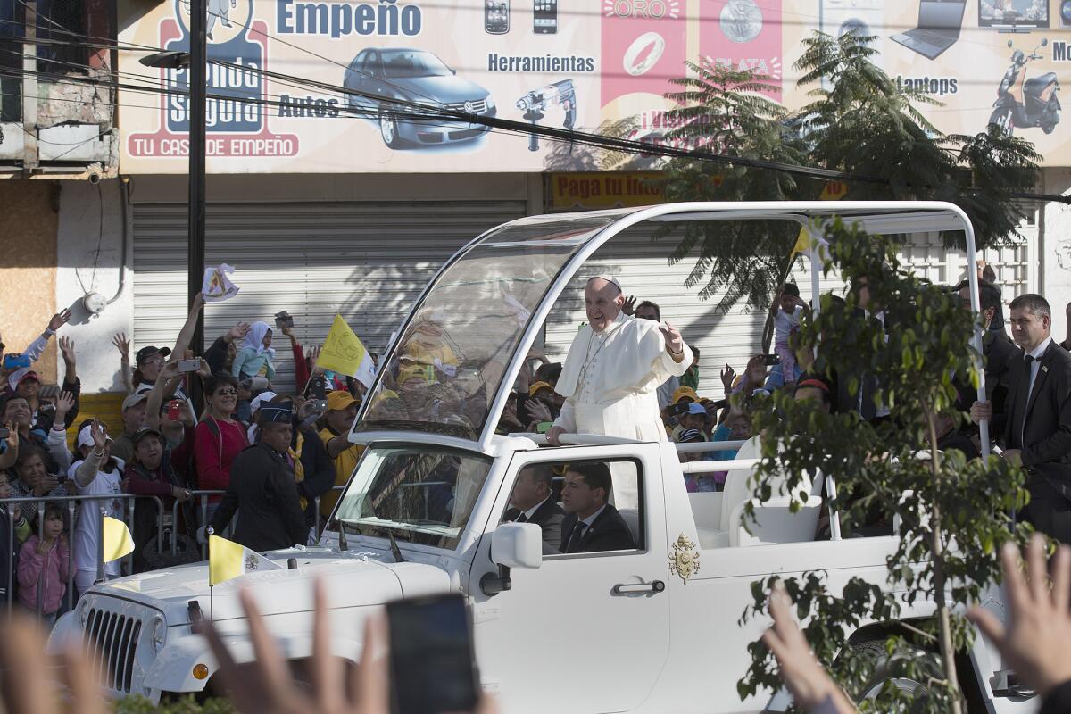 Pope Francis waves as his motorcade approaches the Basilica of Our Lady of Guadalupe during his visit in Mexico City, Calif., on Feb. 13, 2016.