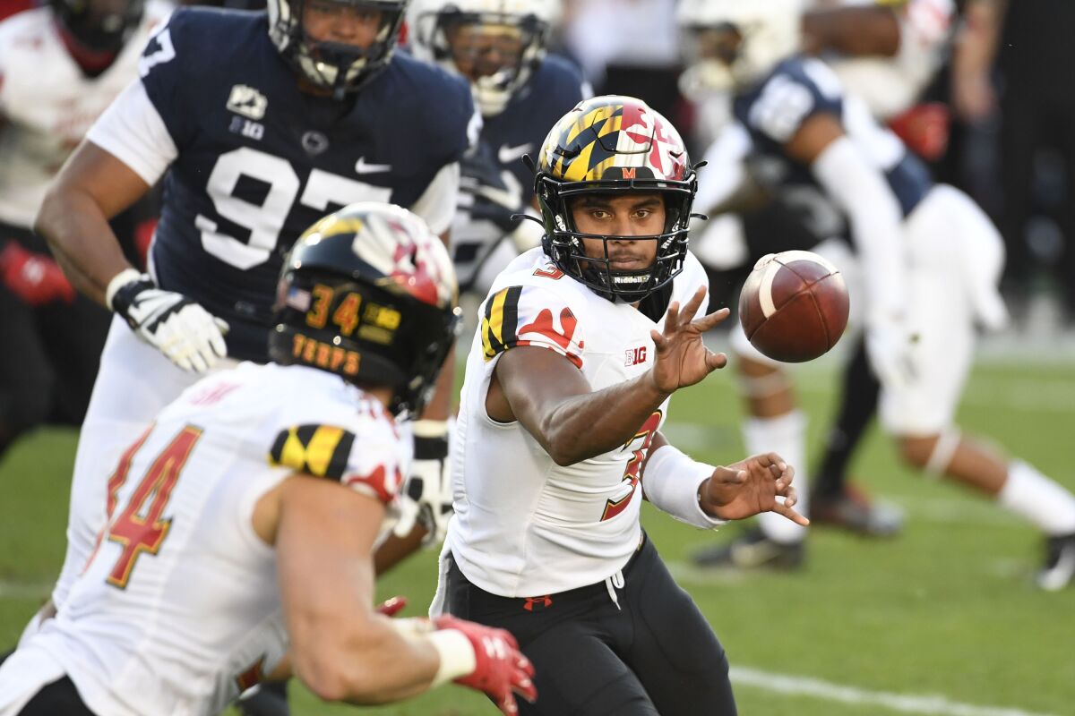 Maryland quarterback Taulia Tagovailoa (3) pitches the ball to Maryland running back Jake Funk (34) against Penn State in the first quarter of an NCAA college football game in State College, Pa., Saturday, Nov. 7, 2020. (AP Photo/Barry Reeger)
