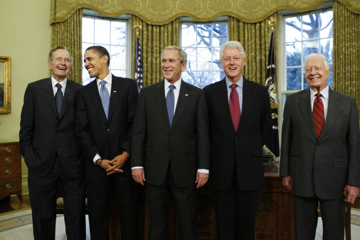 Barack Obama with President George W. Bush and ex-Presidents George H.W. Bush, Bill Clinton and Jimmy Carter stand together.