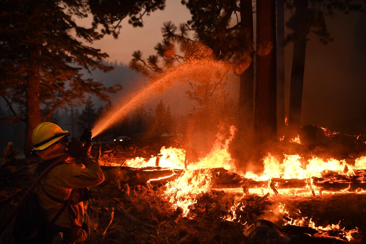 Firefighters battle battle the Caldor fire along highway 89 west of Lake Tahoe.