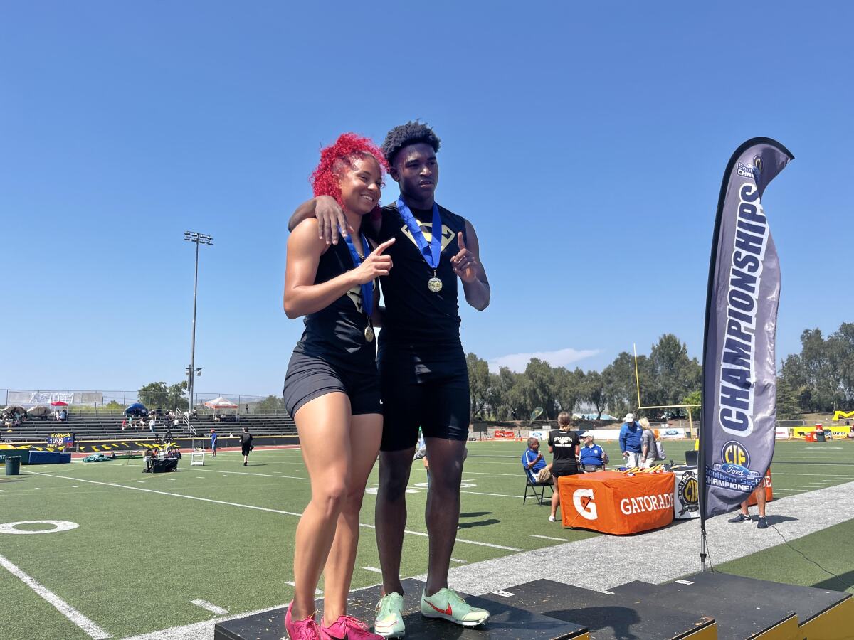 Gardena Serra High's Brazil Neal, left, and Rodrick Pleasant pose for a photo during the Masters Meet on May 20.