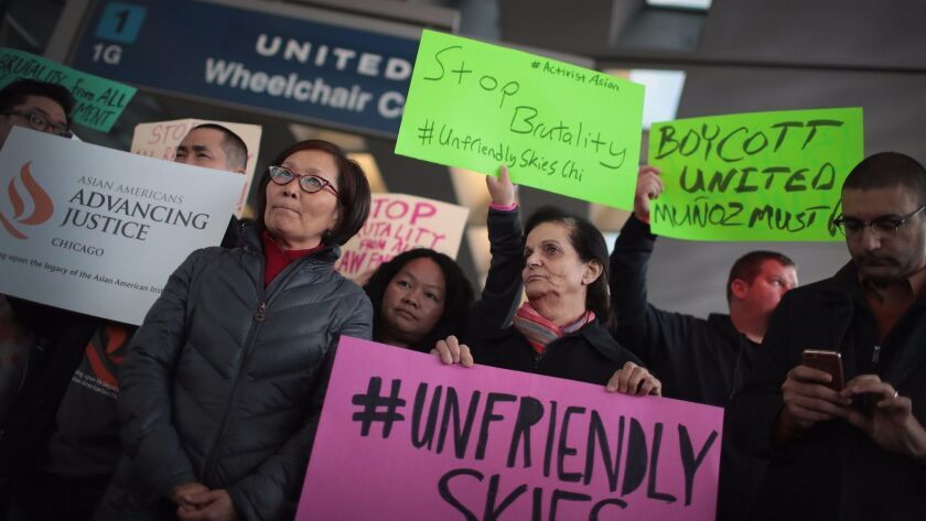 Demonstrators protest outside the United Airlines terminal at O'Hare International Airport on April 11, 2017, in Chicago after a video was posted online showing passenger David Dao being dragged from his seat.