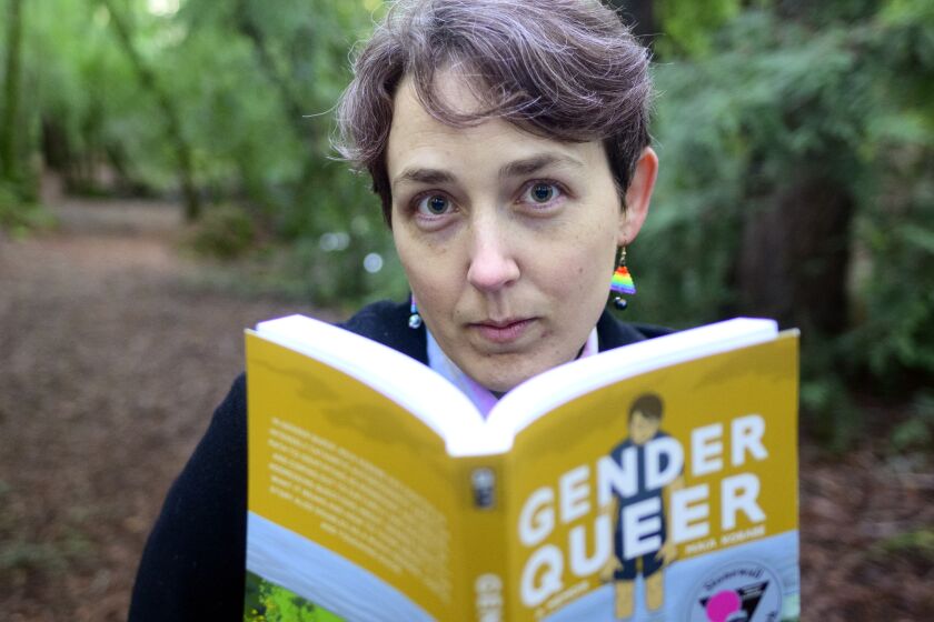 SANTA ROSA, CA - DECEMBER 13, 2022 - Maia Kobabe stands for a photo with her book "Gender Queer: A Memoir" at North Sonoma Regional Park in Santa Rosa, California on December 13, 2022. Kobabe's graphic novel about coming out as nonbinary is the most banned book in America. (Josh Edelson/for the Times)