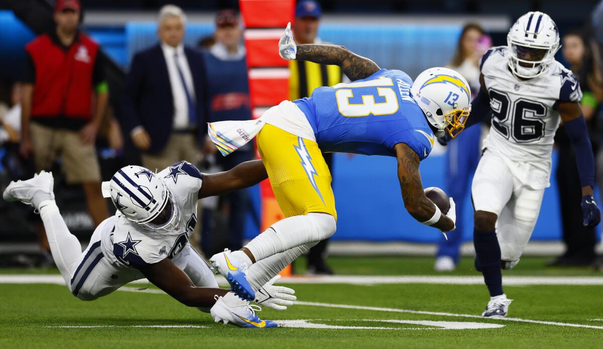 Chargers Keenan Allen presses for more yards after a catch against the Cowboys.