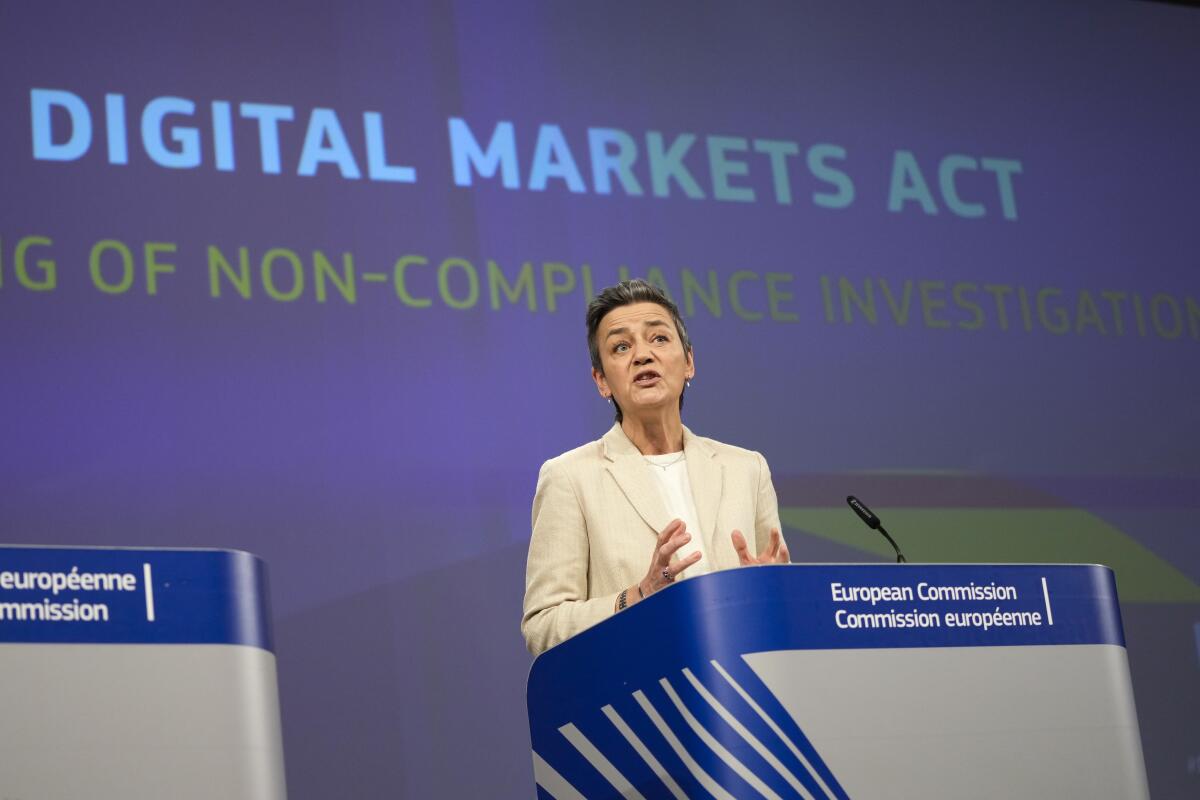 A woman stands at a lectern under the words Digital Markets Act