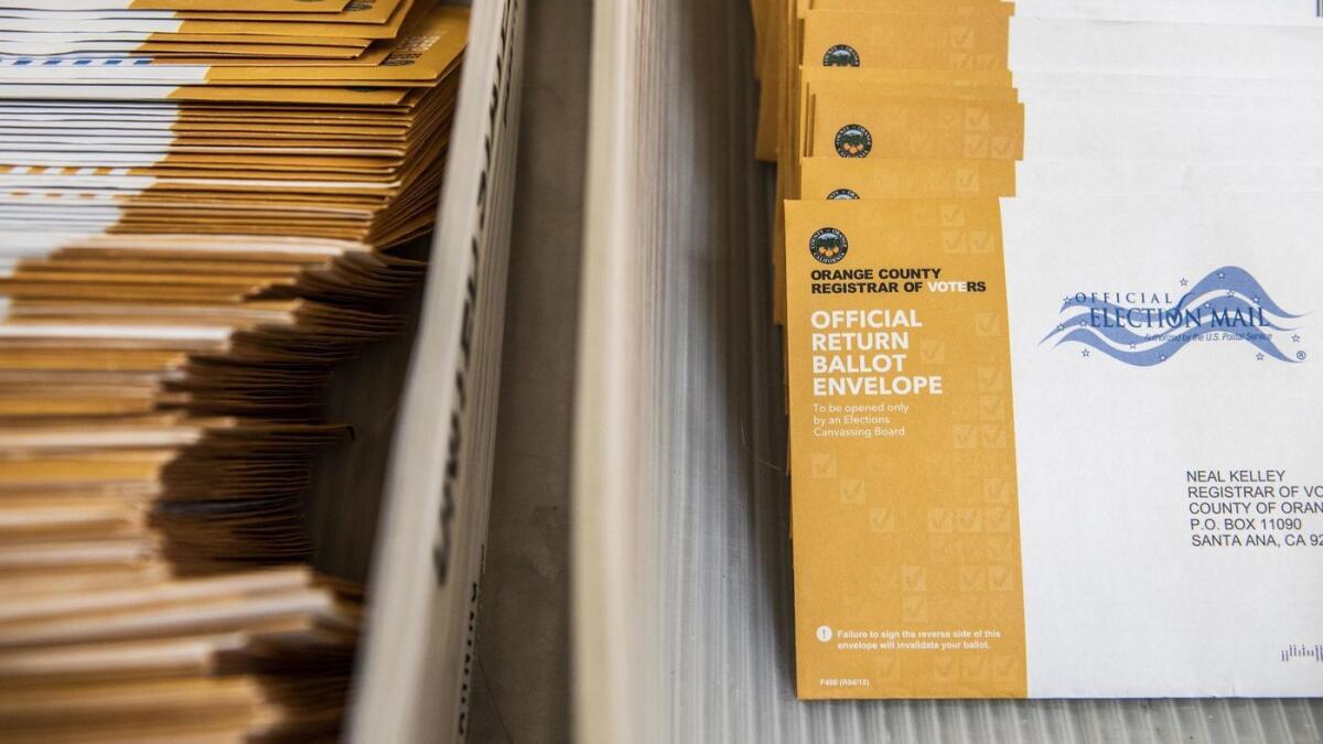 Piles of mail-in ballots are readied to be counted Nov. 7 in Santa Ana.