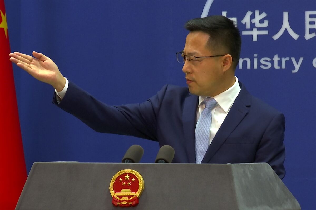 Chinese Foreign Ministry spokesperson Zhao Lijian gestures during a press conference at the Ministry of Foreign Affairs in Beijing, China, Wednesday, Jan. 19, 2022. China on Wednesday condemned plans by Slovenia to upgrade relations with self-governing Taiwan, a move likely to spark diplomatic and economic retaliation against the tiny Balkan country. (AP Photo/Liu Zheng)