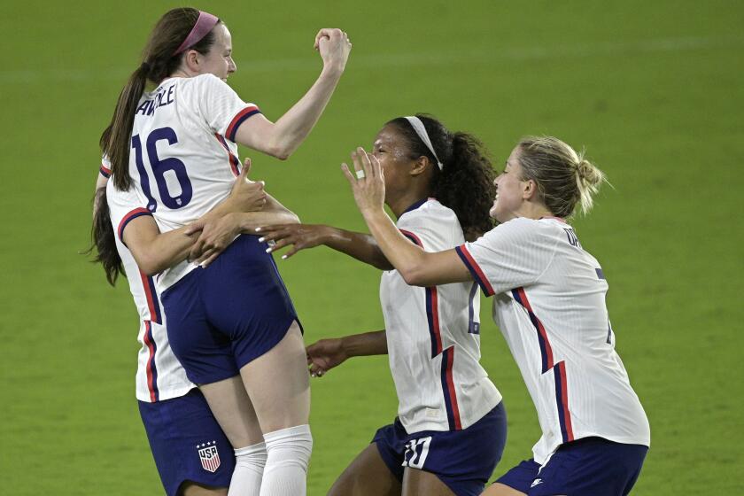 United States midfielder Rose Lavelle (16) is congratulated by teammates after scoring a goal during the second half of a SheBelieves Cup women's soccer match against Canada, Thursday, Feb. 18, 2021, in Orlando, Fla. (AP Photo/Phelan M. Ebenhack)