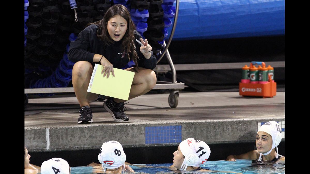Glendale High water polo coach Casey Sripramong talks to her team during the title match of the Pacific League Tournament on Thursday, Feb. 12, 2015.