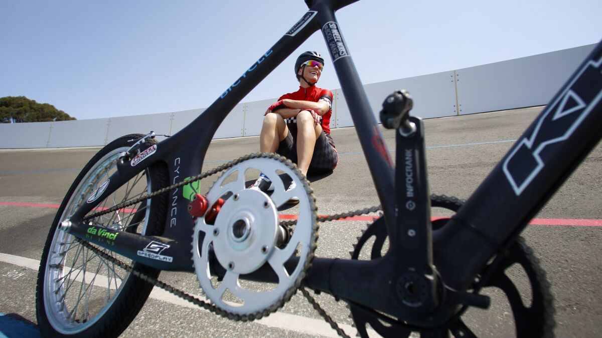 Denise Mueller-Korenek takes a training break at the San Diego Velodrome behind the bike she'll race on for the world paced bicycle speed record.