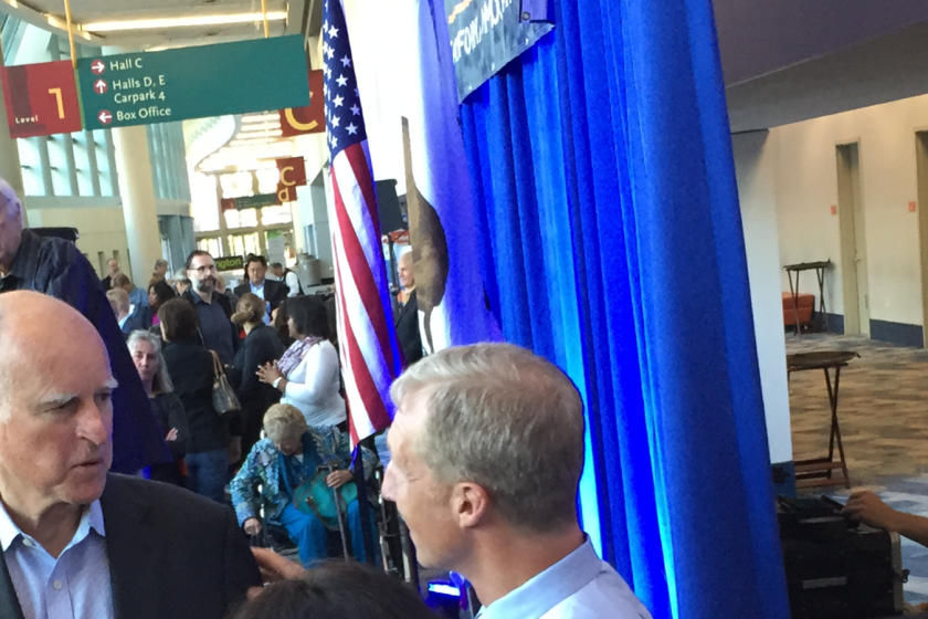 Gov. Jerry Brown speaks Friday with San Francisco billionaire and environmentalist Tom Steyer at the state Democratic convention in Anaheim. Behind Brown is state Democratic chairman John Burton.