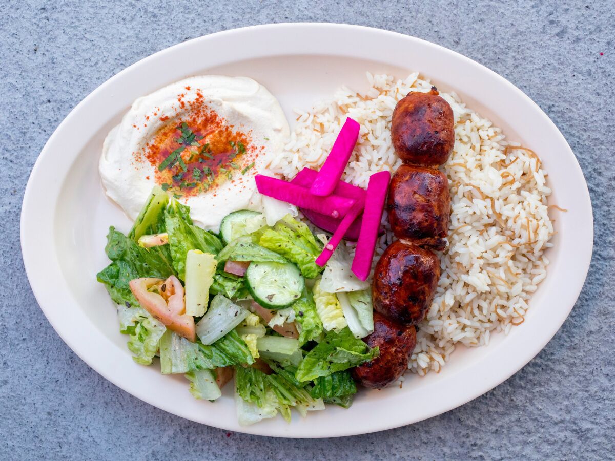 Chorizo kebab served with rice, Lebanese salad and hummus at X'tiosu Kitchen
