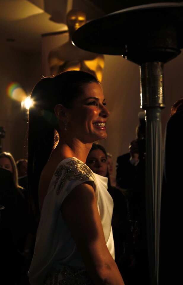 Sandra Bullock, who won the lead actress Oscar in 2010, waits to surprise 2012 winner Meryl Streep outside the Governors Ball.