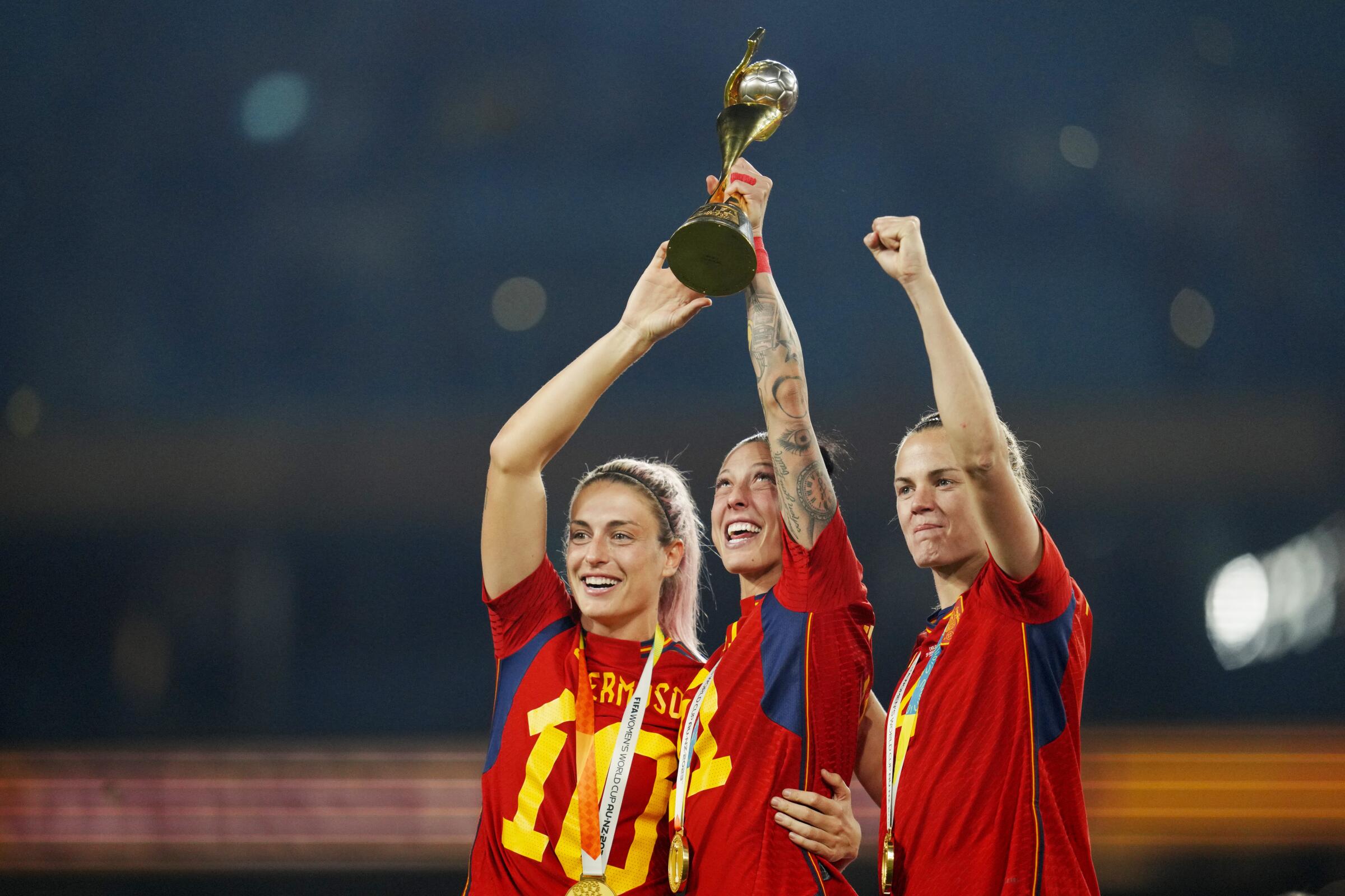 Spain's (from left) Alexia Putellas, Jennifer Hermoso and Irene Paredes celebrate with the Women's World Cup trophy.