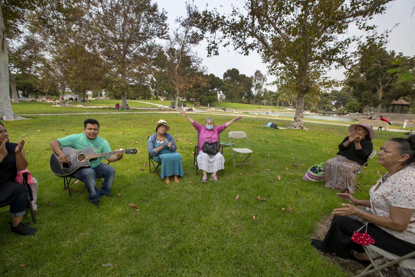 Guitarist Marcelo Sotelo of Anaheim leads members of the Iglesias Pentecostal United Church of Santa Ana in a song.