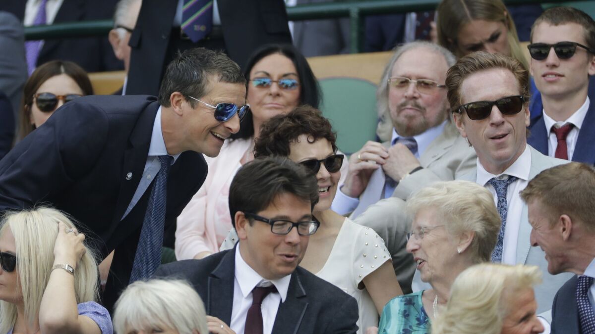 "Man vs. Wild" star Bear Grylls, left, takes his seat in the royal box on Centre Court at Wimbledon on Friday.
