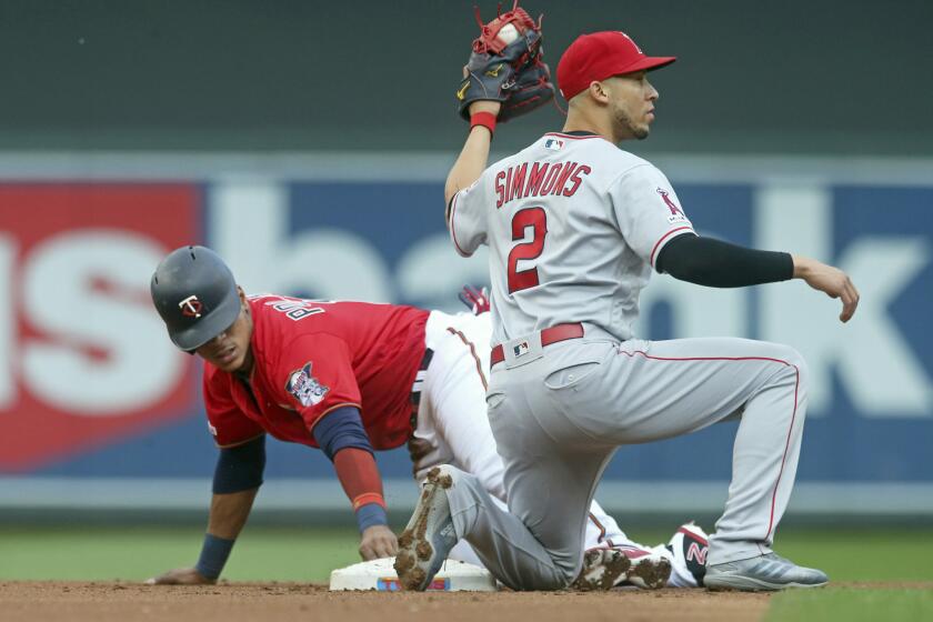 Los Angeles Angels second baseman Andrelton Simmons, looks for the call as Minnesota Twins' Jorge Polanco steals second base in the first inning of a baseball game Tuesday, May 14, 2019, in Minneapolis. (AP Photo/Jim Mone)