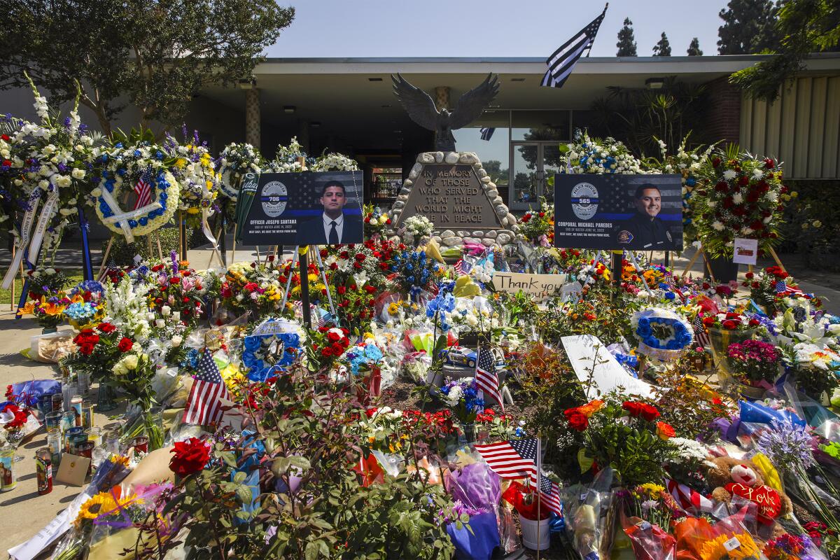 A memorial for two slain police officers outside the El Monte Police Department headquarters on June 16