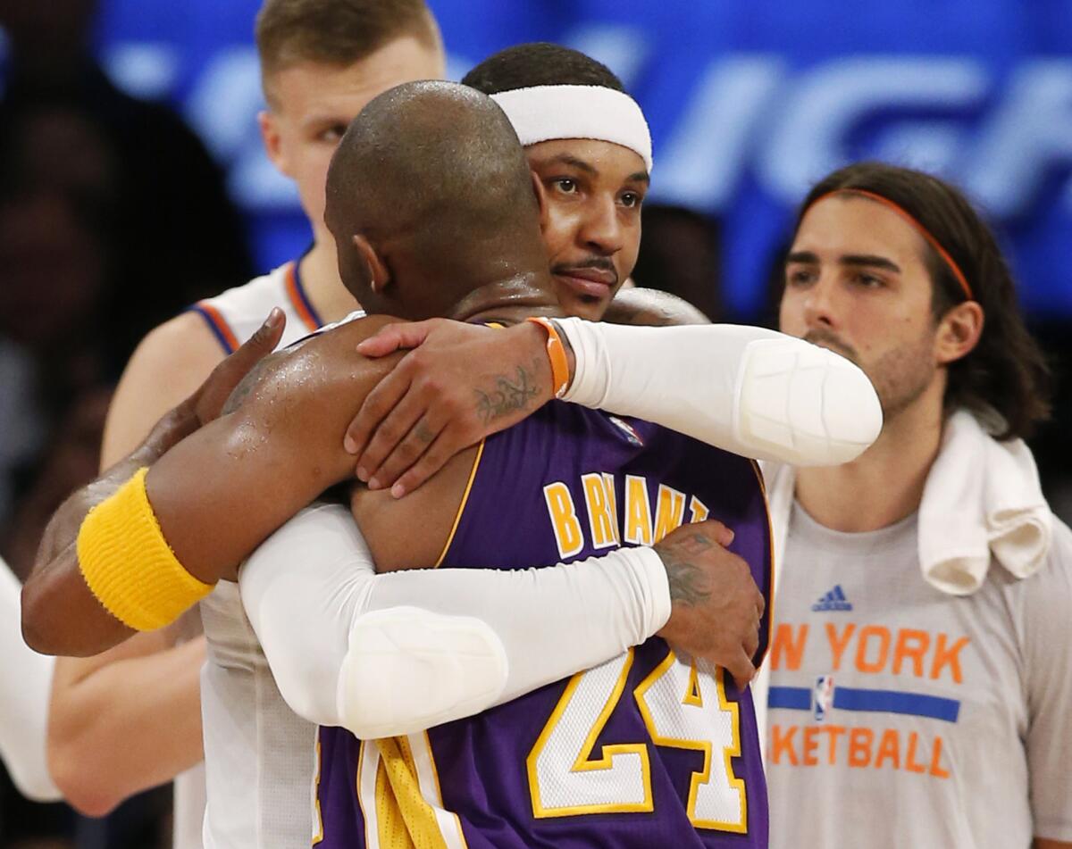 Knicks forward Carmelo Anthony embraces Lakers forward Kobe Bryant after their game Sunday.