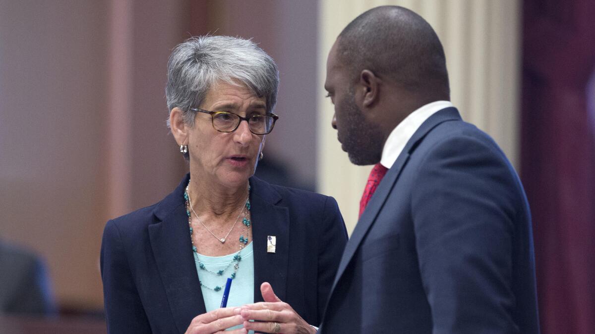 Assemblyman Tony Thurmond (D-Richmond) speaks with Sen. Hannah-Beth Jackson (D-Santa Barbara)