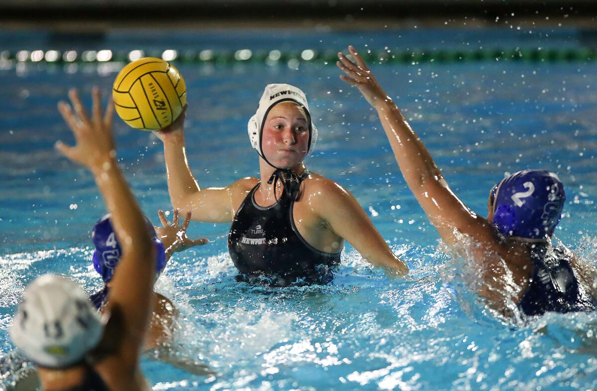 Newport Harbor’s Taylor Smith takes a shot between Santa Margarita’s Carly McMurray (4) and Mara Loughlin (2) and scores in the fourth quarter of a CIF Southern Section Division 1 playoff opener on Feb. 13.