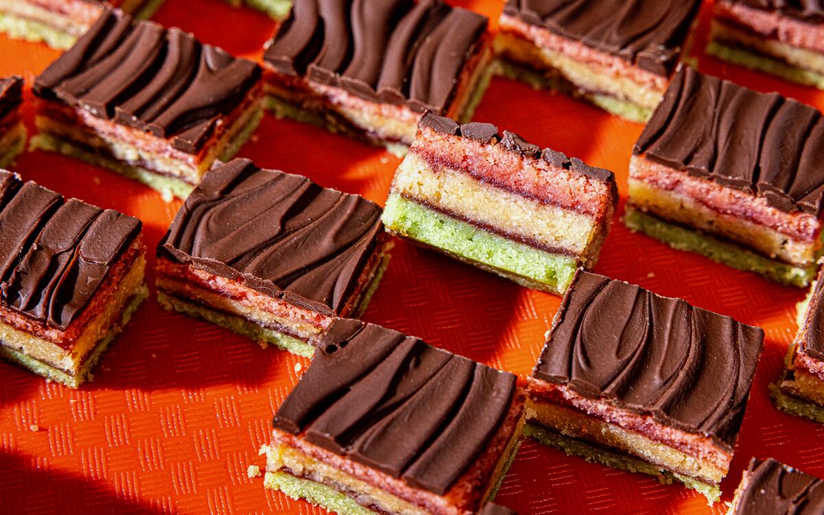 Bar cookies with green, yellow and pink layers, topped with chocolate frosting