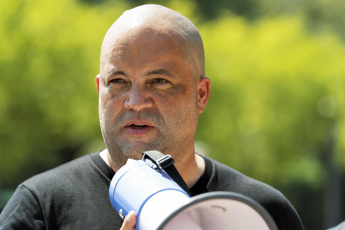 a man holds a megaphone