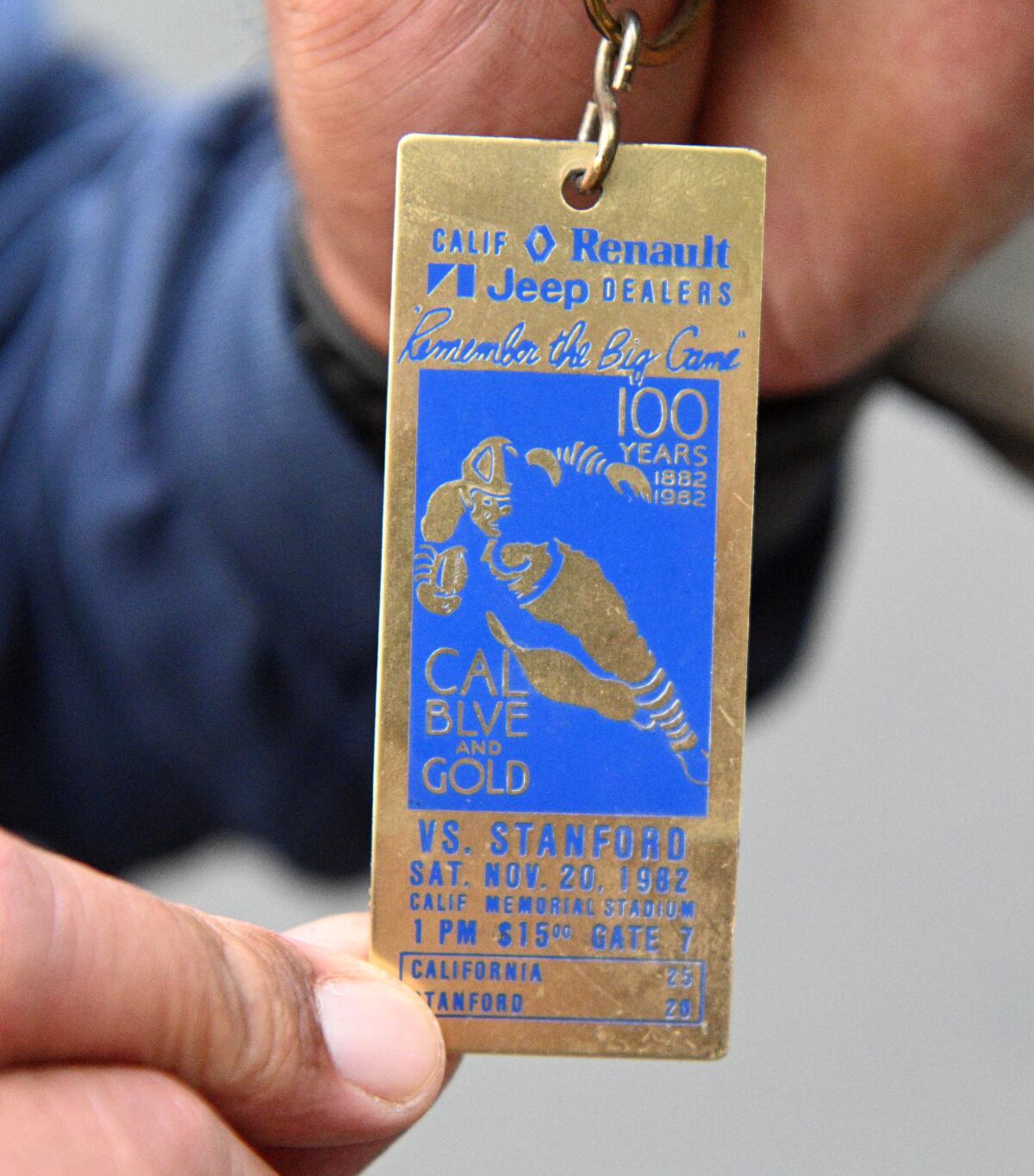 Former Cal player George Niualiku displays an old keychain that harkens back to "The Play." 