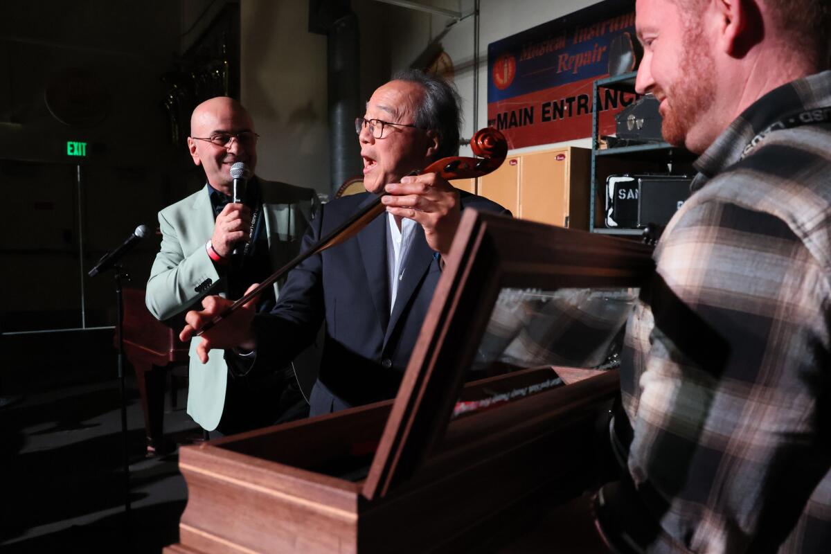 Yo-Yo Ma with Steve Bagmanyan, left, store manager for the LAUSD's instrumentality repair program.
