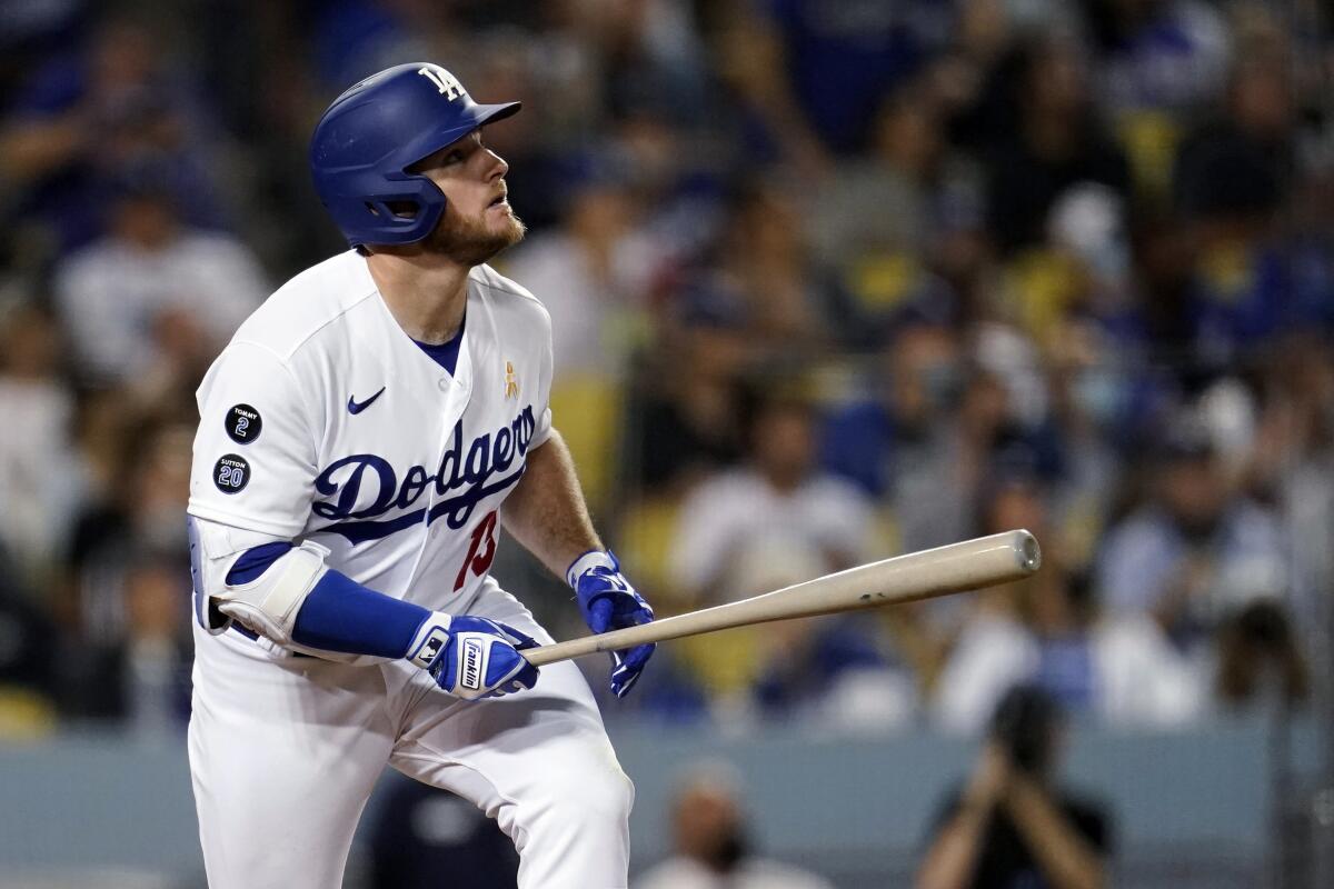 Max Muncy hits a triple against the Atlanta Braves on Sept. 1.