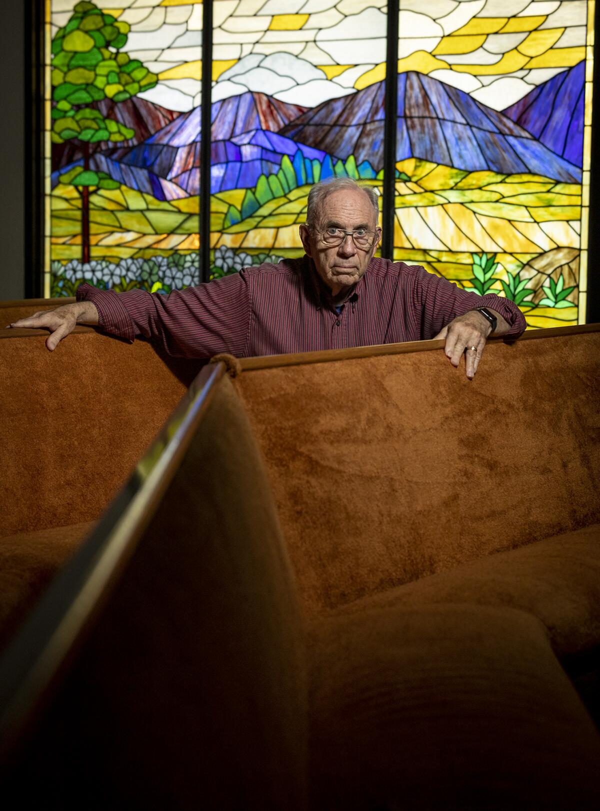John Leonard of Surf City Church, sits in a pew at the Huntington Beach church.