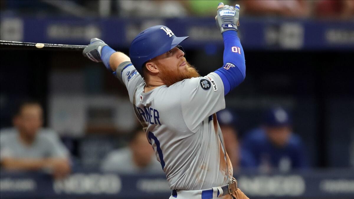 Dodgers third baseman Justin Turner hits a fly ball against the Tampa Bay Rays on May 20. Dave Roberts wants to make sure Turner remains healthy.