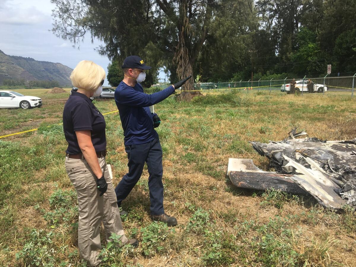 Elliott Simpson, right, briefs Jennifer Homendy at the scene of a plane crash in Waialua, Hawaii.