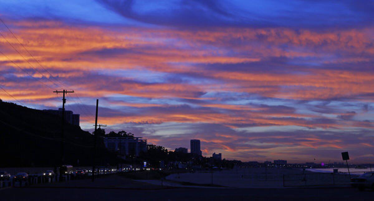 Weather in Southern California is about to change, with a cold front on the way that may bring rain to the Los Angeles area. Above, the sun is about to rise over Santa Monica.