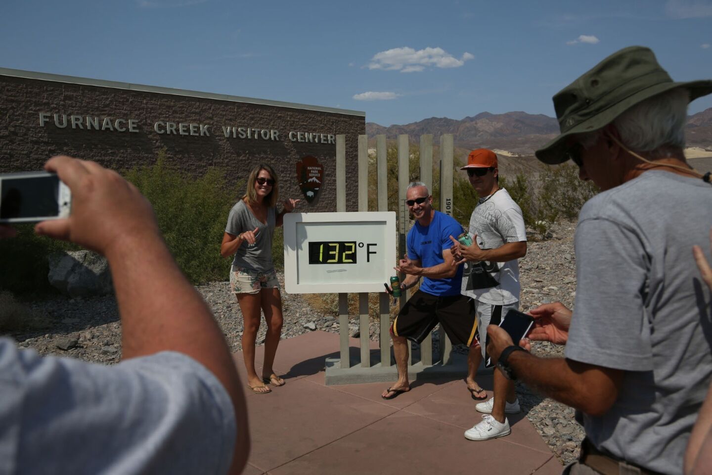 Sarah Mason, left, and Lance Lindsey, both from Los Angeles, and Joey Teixeira of Honolulu have their picture taken with of a thermometer -- showing 132 degrees -- at the Furnace Creek Visitor Center in Death Valley.