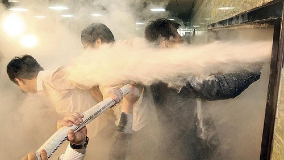 Opposition lawmakers, upon breaking through a door to a conference room at the South Korean National Assembly in Seoul, are sprayed with fire extinguishers by rival politicians inside. More photos >>>