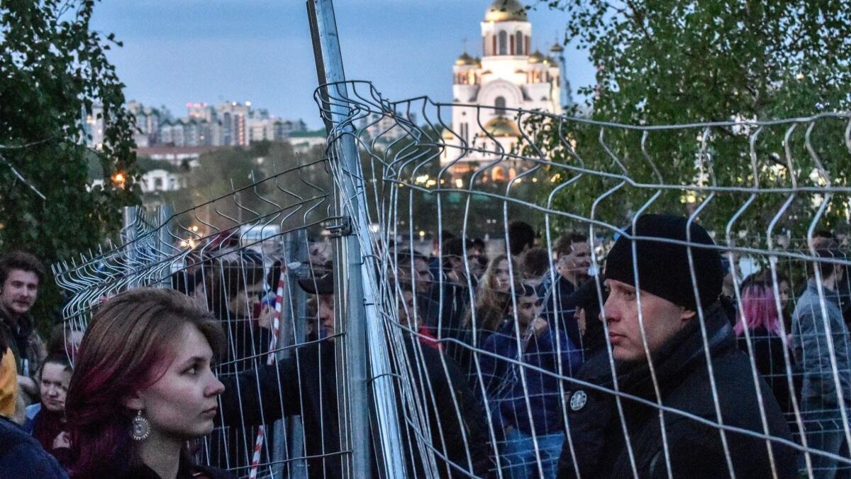 Activists protesting a plan to build a Russian Orthodox cathedral gather around a fenced-off construction site in a park in Yekaterinburg on May 14.