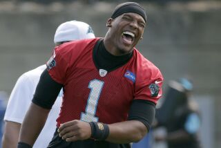 Carolina Panthers' Cam Newton laughs as the team stretches during an NFL football practice in Charlotte, N.C., Thursday, June 16, 2016. (AP Photo/Chuck Burton)