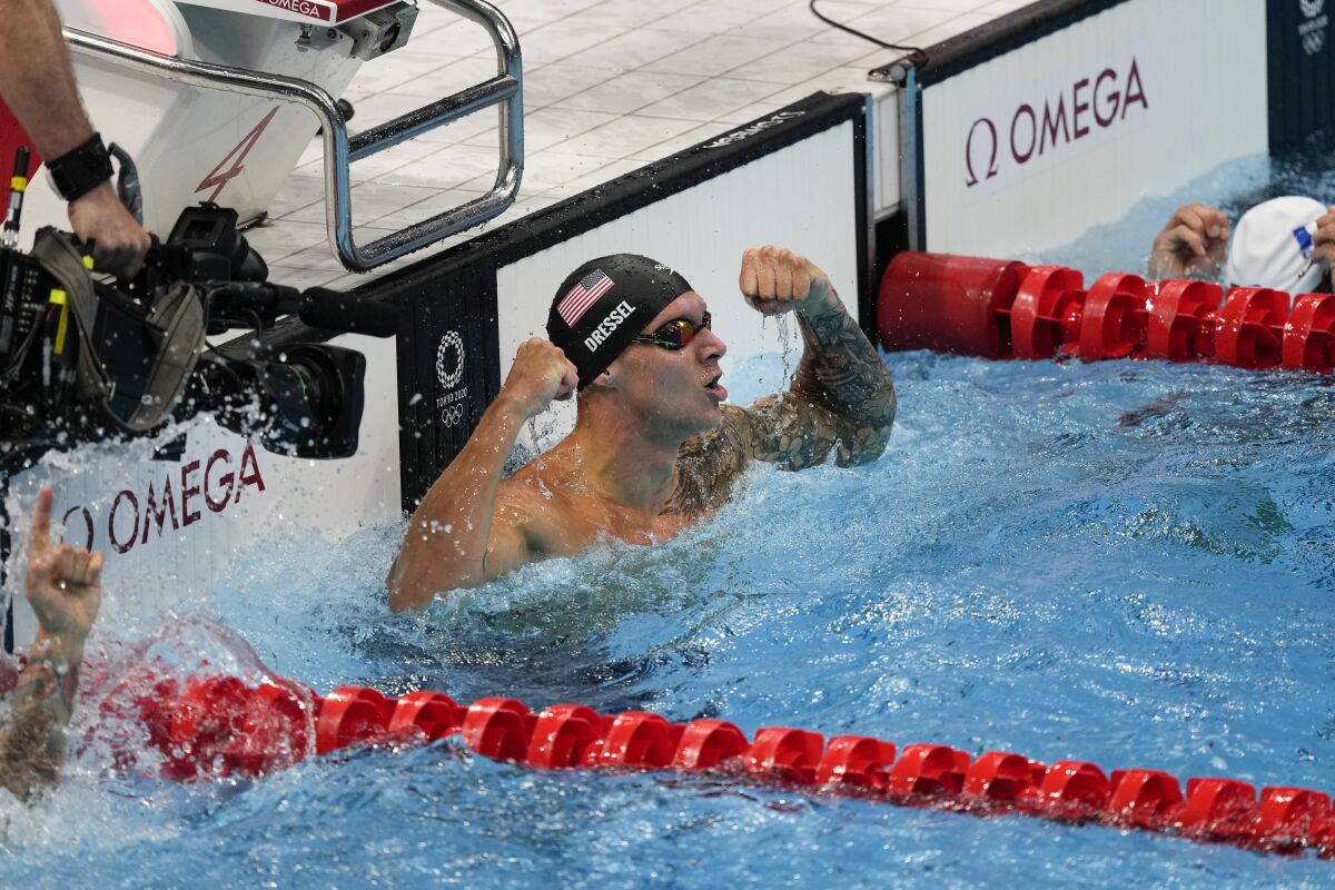 Caeleb Dressel, of the United States, celebrates after winning the gold medal in the men's 50-meter freestyle final at the 2020 Summer Olympics, Sunday, Aug. 1, 2021, in Tokyo, Japan. (AP Photo/Jae C. Hong)