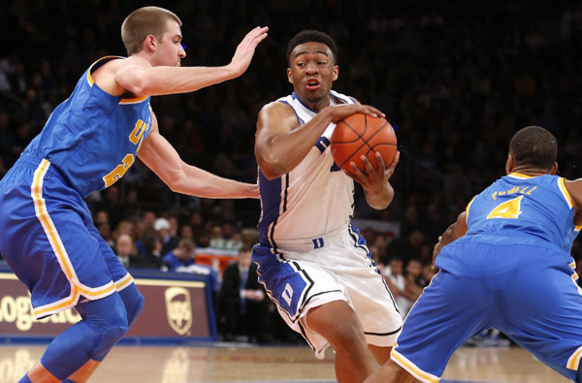 UCLA forward Travis Wear and guard Norman Powell defend against Duke forward Jabari Parker during a non-conference game earlier this season.