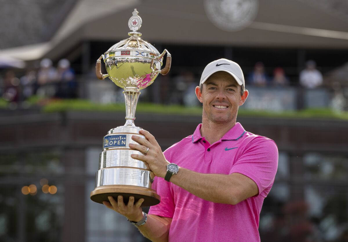Rory McIlroy holds the trophy for his victory in the Canadian Open.
