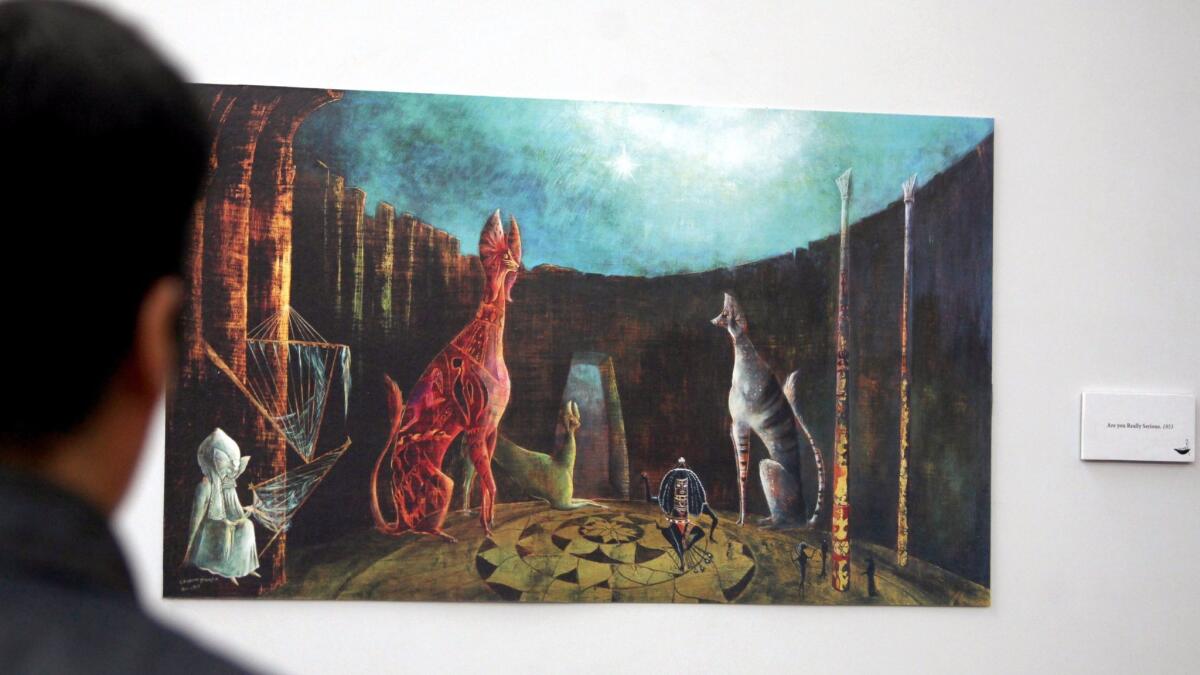 Viewing a painting by Leonora Carrington at an exhibit in Mexico City in April.