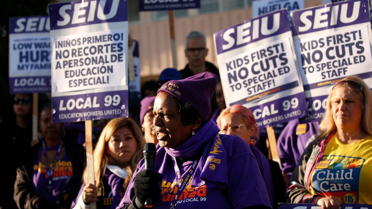 L.A. school custodian Edna Logan joins other SEIU Local 99 workers Monday as they march at Marlton School in Baldwin Hills.