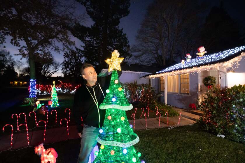 Mark Robins, vice president of Roku Smart Home at his holiday decorated home on Wednesday, Dec. 14, 2022 in Palo Alto, Calif. The light show caught the attention of Roku's CEO and led to Robins getting a job at the company.