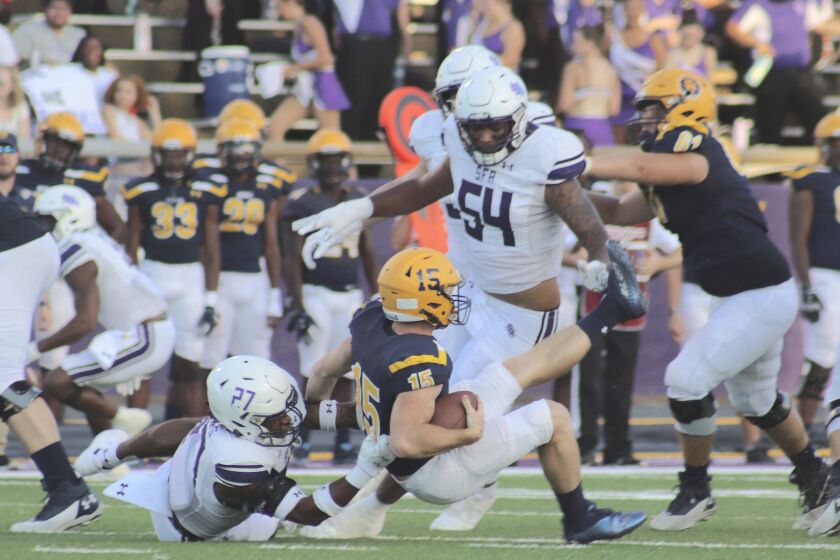 Stephen F. Austin safety JaTerious Evans brings down the Warner quarterback for a sack during an NCAA college football game Saturday, Sept. 24, 2022 in Nacogdoches, Texas. (Nathan Hague/The Daily Sentinel via AP)