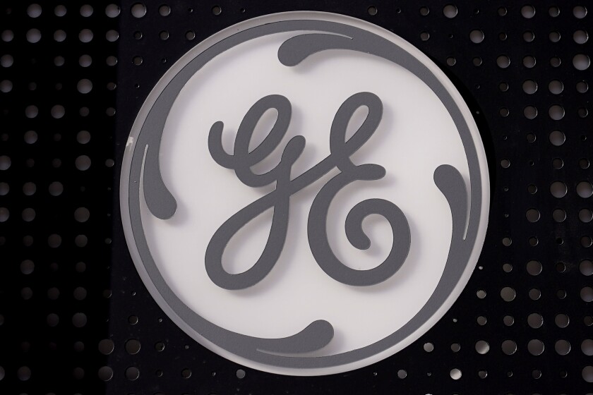 FILE - The General Electric logo is displayed on a sign outside their headquarters, Nov. 10, 2021, in Boston. General Electric has decided on the names it will give to the three companies that it plans to divide itself into. GE said Monday, July 18, 2022 that the healthcare business will be named GE Healthcare; the aviation business will be called GE Aerospace; and its energy businesses, including GE Renewable Energy, GE Power, GE Digital, and GE Energy Financial Services, will be named GE Vernova. (AP Photo/Charles Krupa, file)