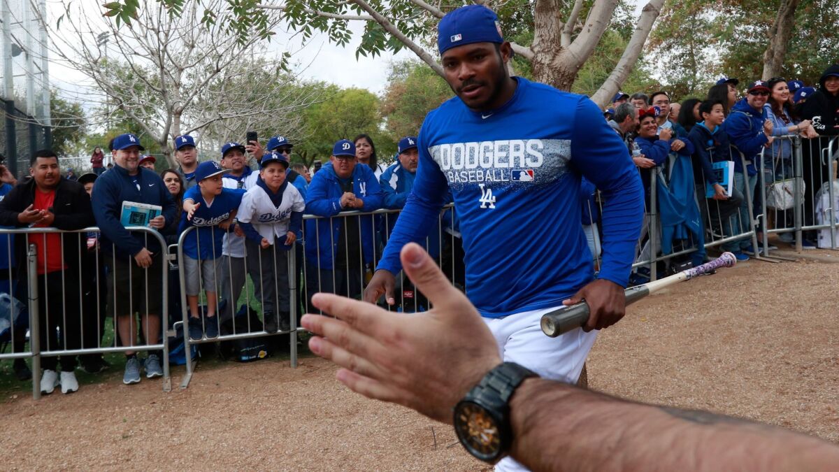 Dodgers outfielder Yasiel Puig is greeted by fans on Feb. 19.