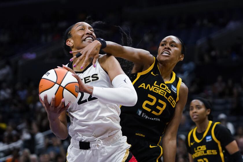 Las Vegas Aces forward A'ja Wilson (22) looks for a shot as Los Angeles Sparks forward Azura Stevens (23) defends during the first half of a WNBA basketball game Wednesday, July 12, 2023, in Los Angeles. (AP Photo/Ryan Sun)