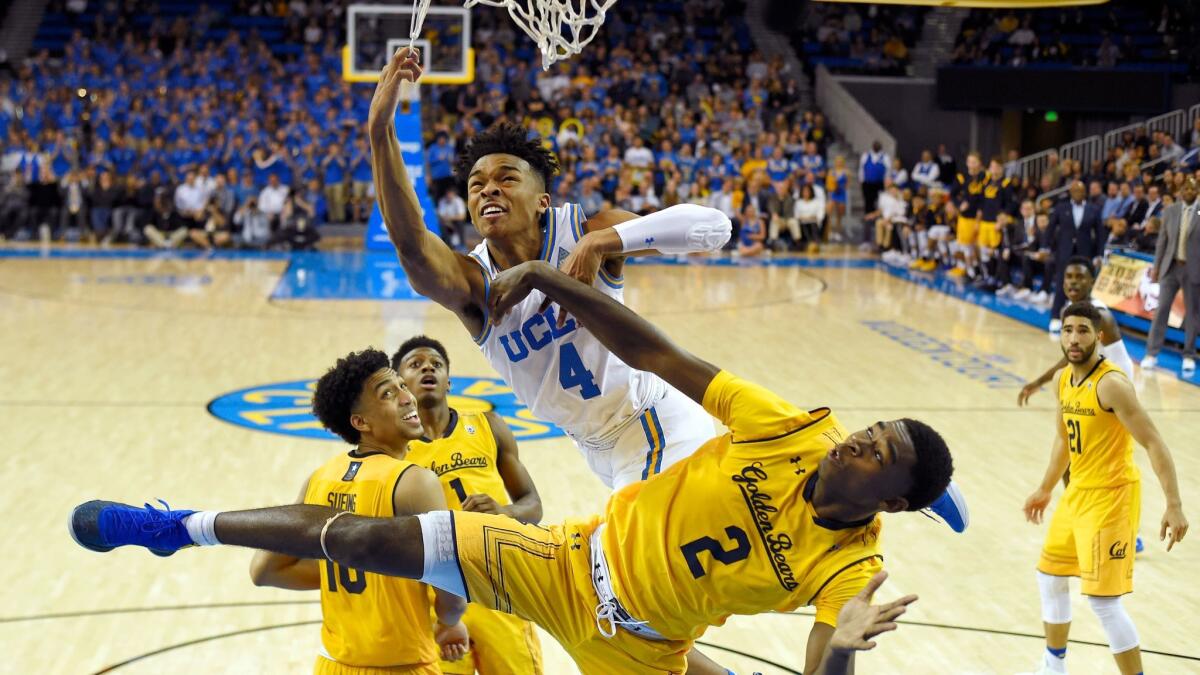 UCLA's Jaylen Hands falls along with California's Juhwan Harris-Dyson (2) after missing a dunk on Thursday.